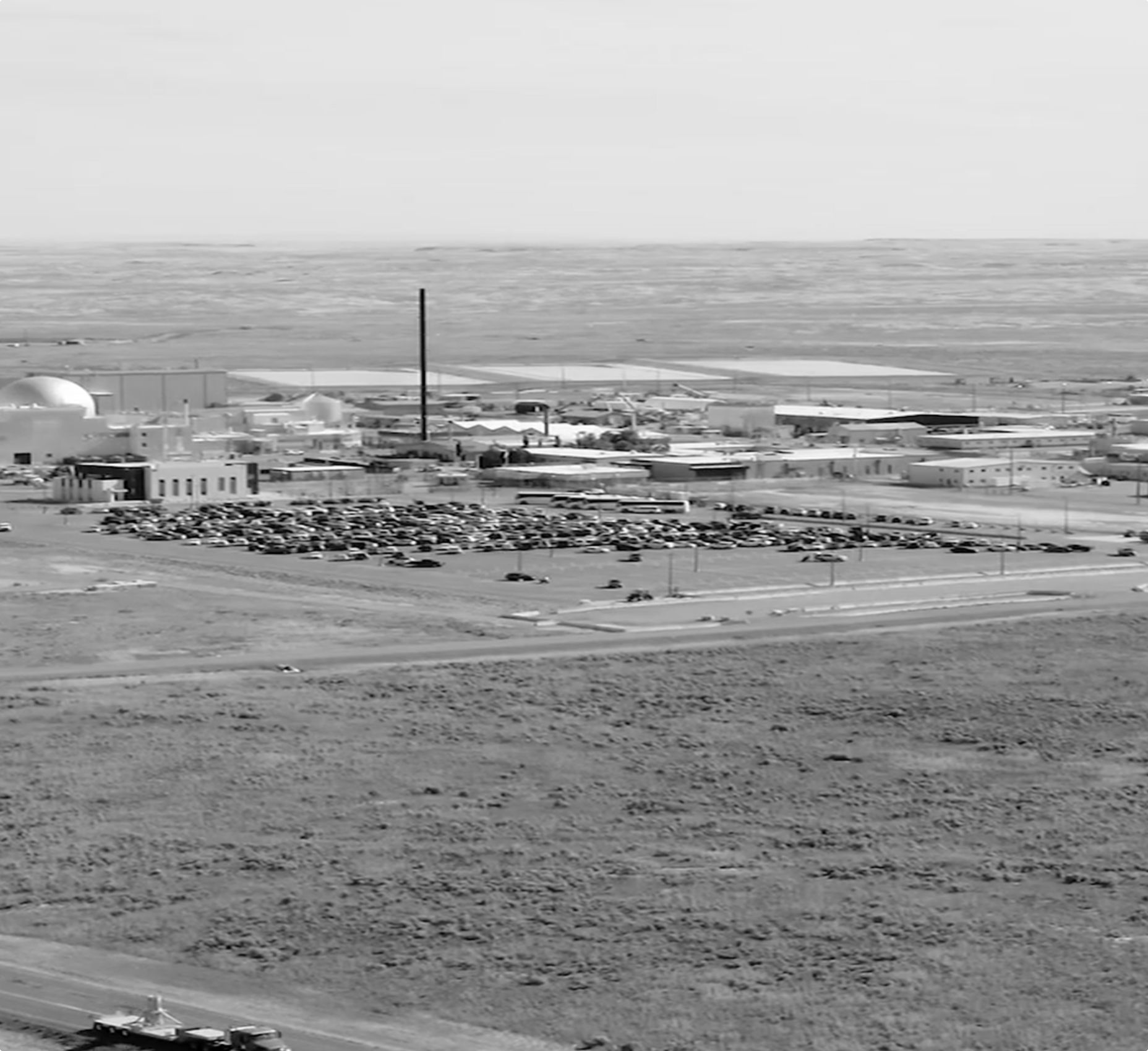 Hazy aerial view of a reactor test site and its car park on open plains